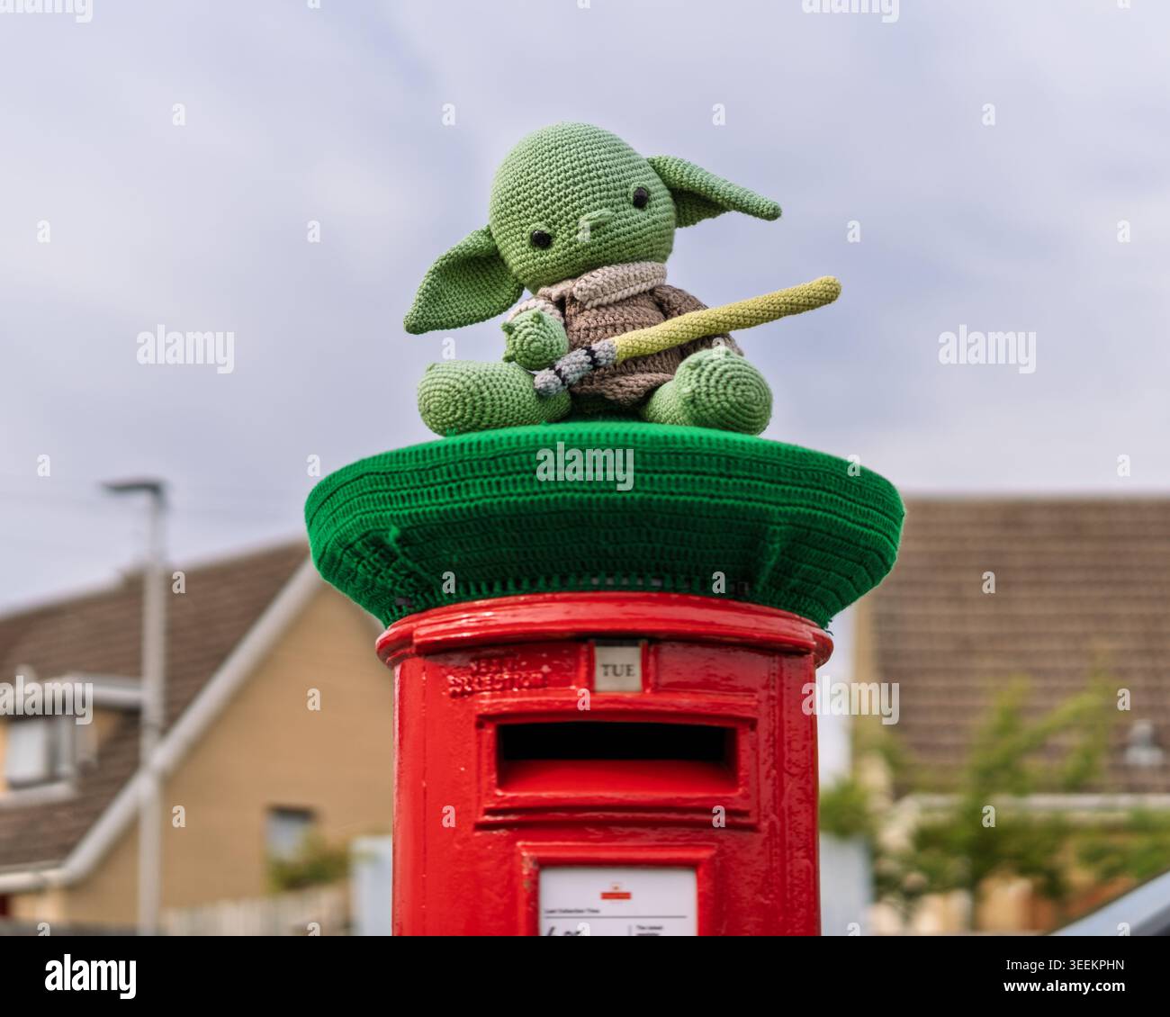 Kinloss, Moray, Scozia. 12 maggio 2026. Un personaggio Yoda a maglia verde si trova su una bomba in filato verde scuro sopra una Post Box rossa. Questa mostra all'aperto illumina Kinloss, Moray, Scozia durante il giorno. Crediti: JASPERIMAGE/Alamy Live News Foto Stock
