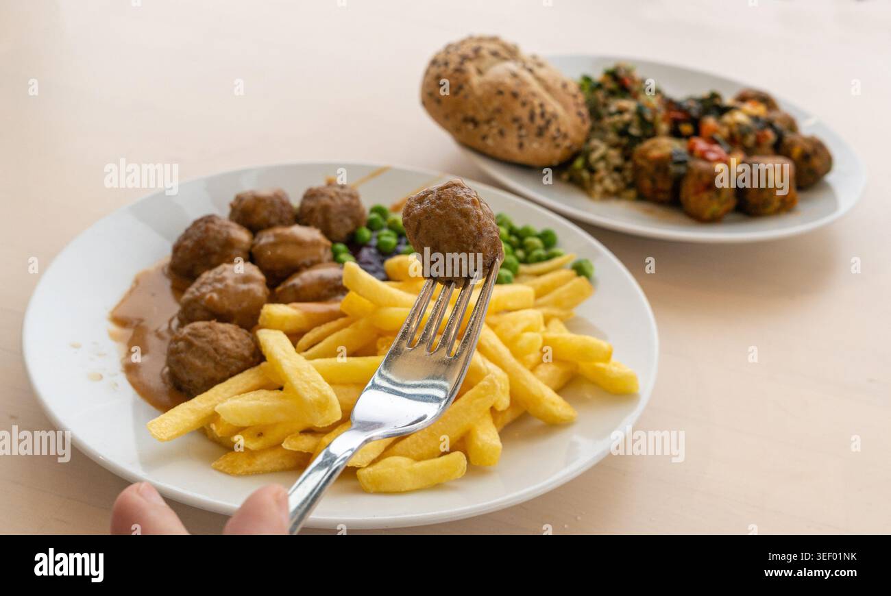 Polpette con patatine fritte, piselli verdi, salsa di besciamella e marmellata di mirtilli, polpette di carne su piatto bianco primo piano tipico del cibo svedese, vitoulet belga me Foto Stock