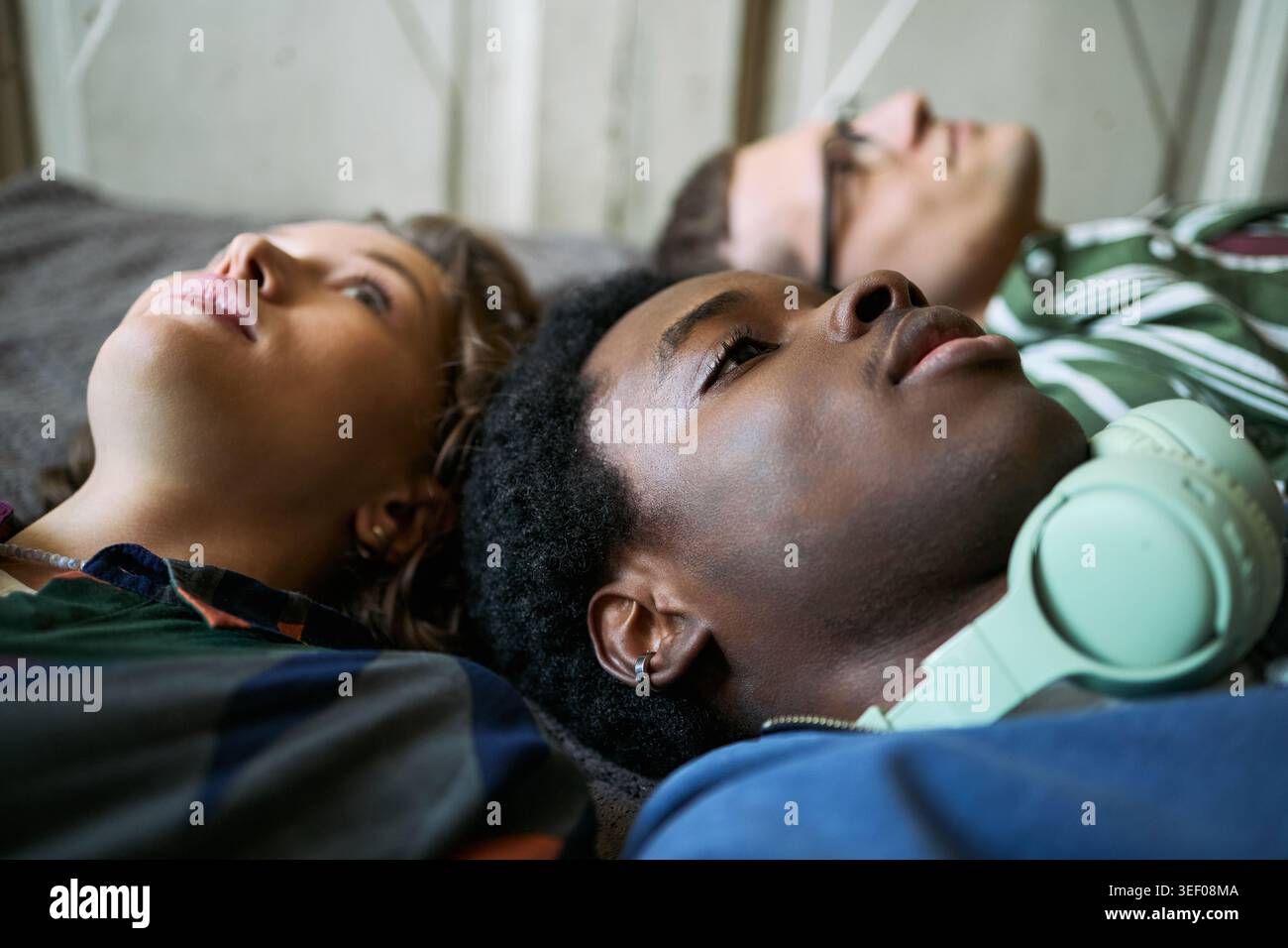 Primo piano di adolescenti diversi che si riposano insieme e si rilassano, riflettendo sull'amicizia, l'identità e il benessere mentale. Utile per il sostegno dei giovani, l'inclusione o le campagne di benessere Foto Stock