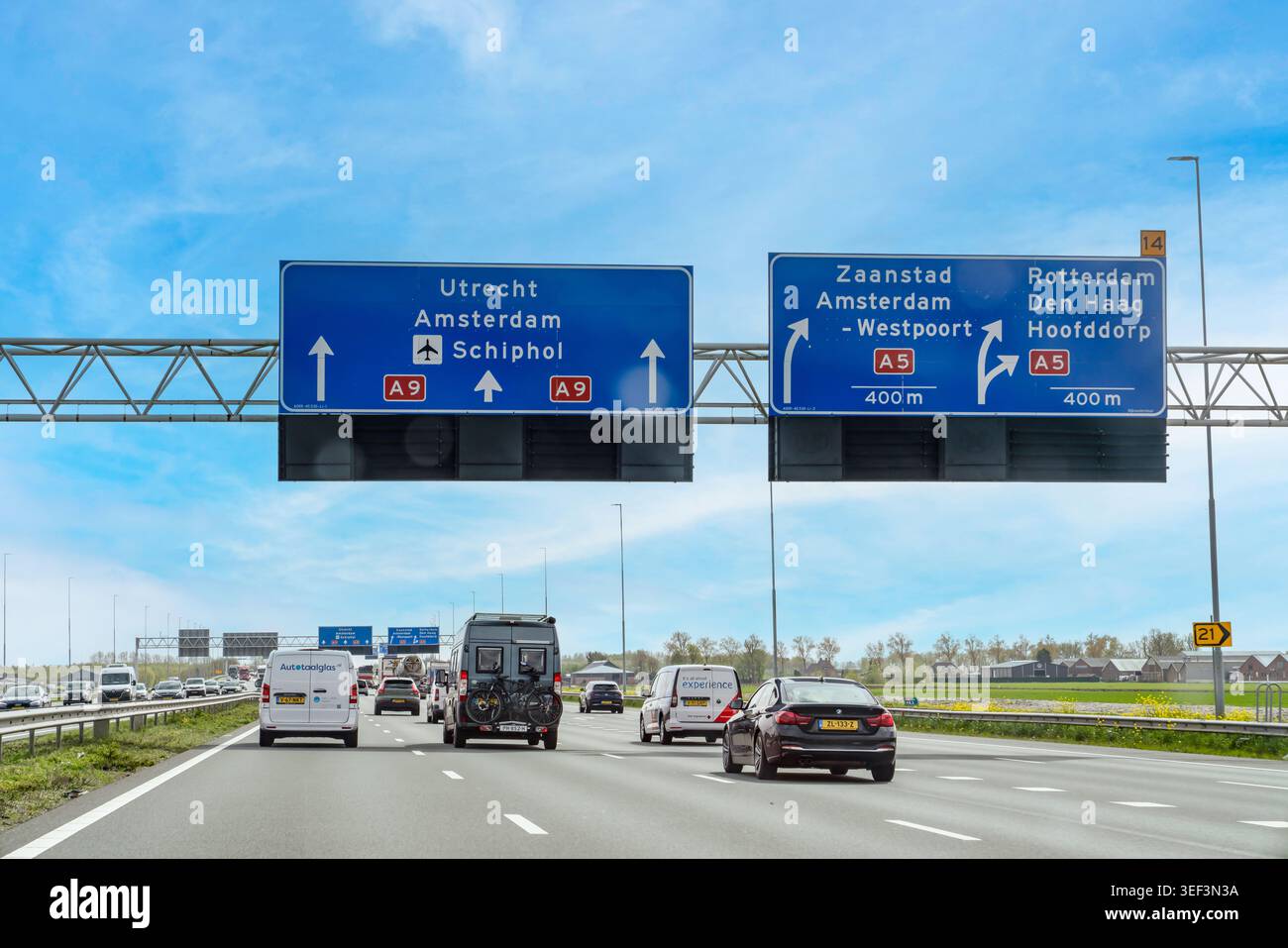 Paesi Bassi - 17 aprile 2026: Traffico che scorre sotto i grandi cartelli blu dell'autostrada A9, che forniscono indicazioni per Utrecht, Amsterdam-W. Foto Stock