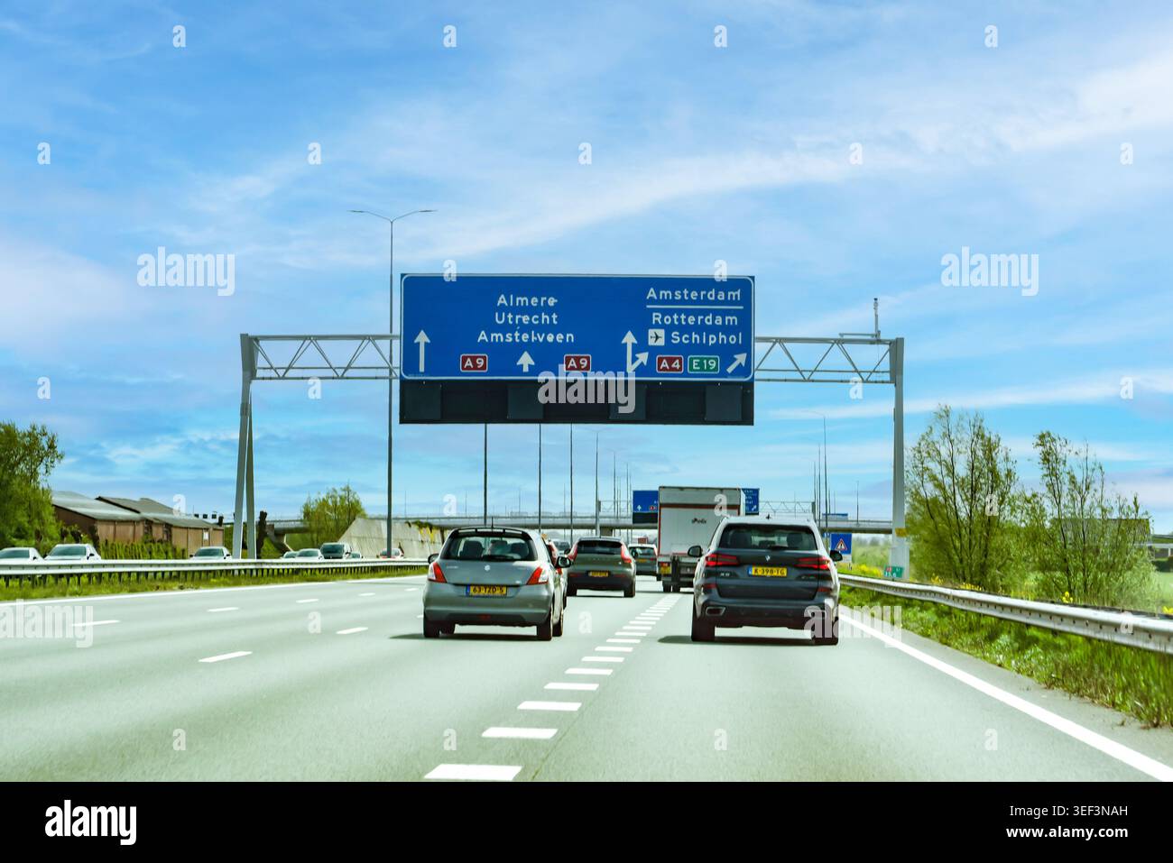 Paesi Bassi - 17 aprile 2026: Traffico sull'autostrada A9 in prossimità di uno svincolo principale con indicazioni stradali per Almere, Utrecht, Amstelveen, Amsterdam, R. Foto Stock