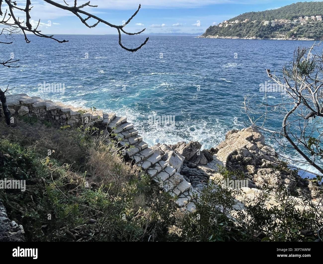 Saint-Jean-Cap-Ferrat, Francia. Il sentiero costiero Chemin des Douaniers, con lo splendido paesaggio della baia. - Immagine stock catturata con smartphone