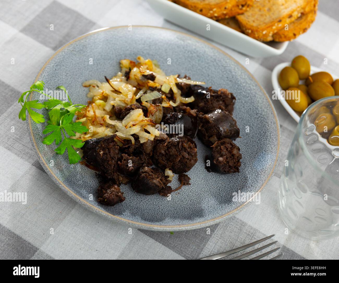Morcilla con cebolla - salsiccia di sangue fritta con cipolla sul tavolo Foto Stock