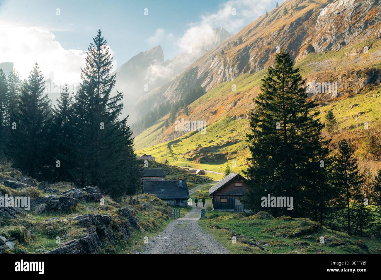 Paesaggio alpino in autunno in Svizzera con escursionisti lungo i tradizionali chalet, Seealpsee, regione dell'Appenzello, Svizzera Foto Stock