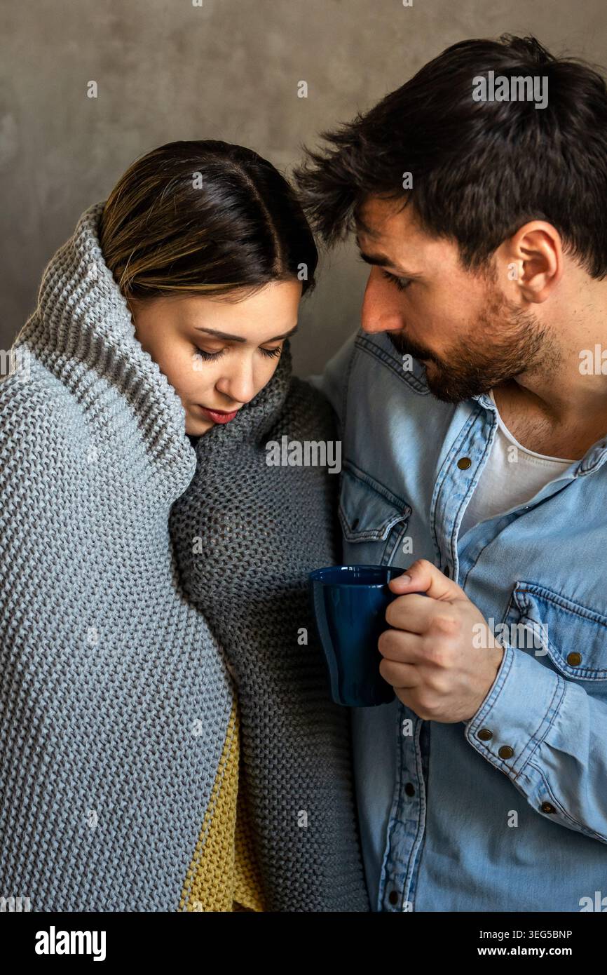 Una coppia ammalata si sostiene a vicenda attraverso sintomi influenzali, affaticamento e momenti di recupero tranquilli Foto Stock