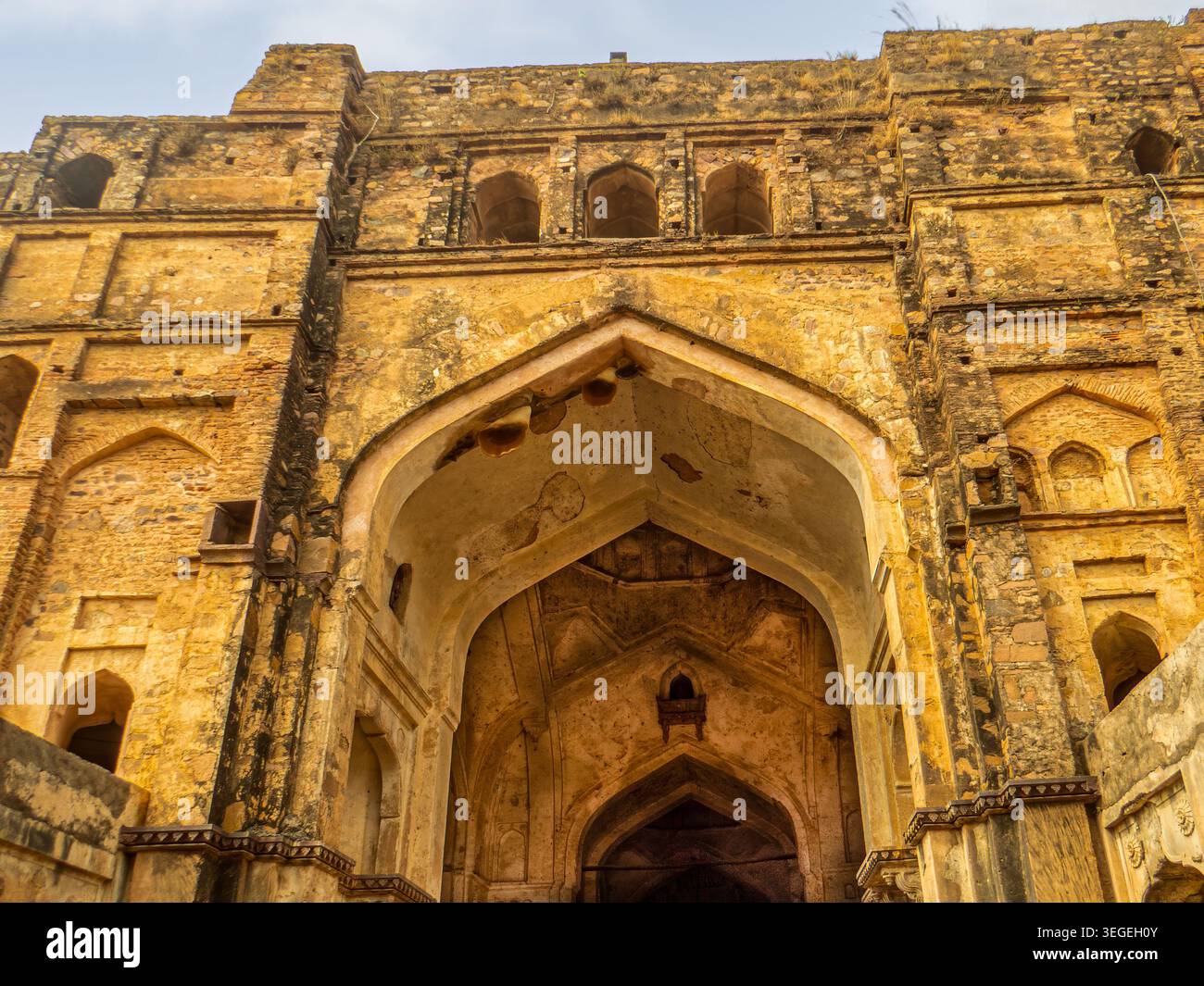 Orchha, India, 22.02.20. Una vista dall'angolo basso degli archi in pietra e delle masse in muratura dell'ingresso allo storico forte di Orchha a Madhya Prad Foto Stock