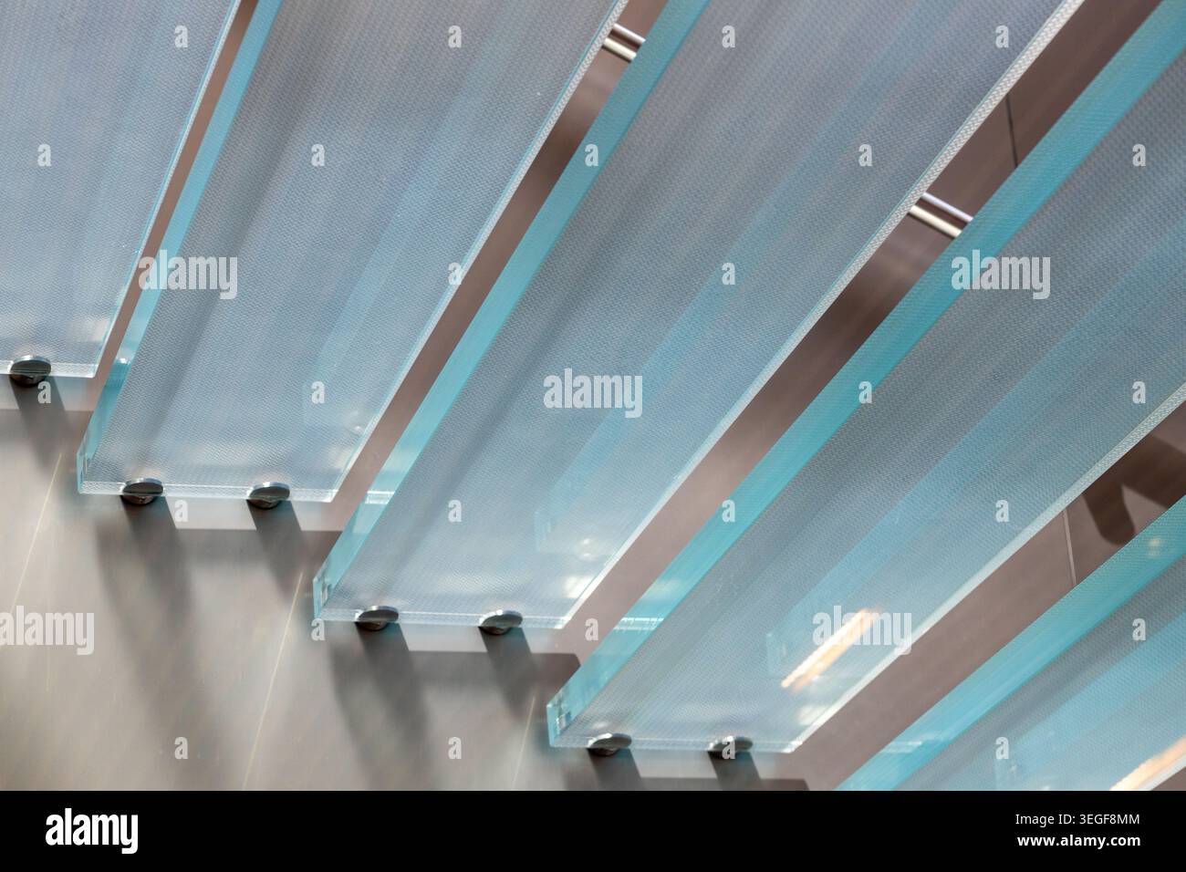 Primo piano dei pannelli in vetro di sicurezza laminato con superficie antiscivolo e antiscivolo, fissati con supporti in vetro con fissaggio a punti in metallo (distanziatori). A ad alta tecnologia Foto Stock