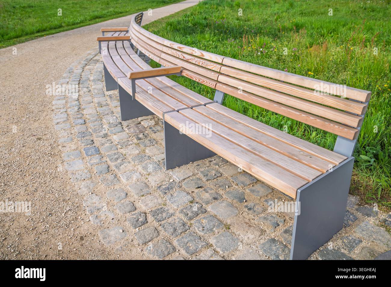 Moderna panca vuota in legno in un parco Foto Stock