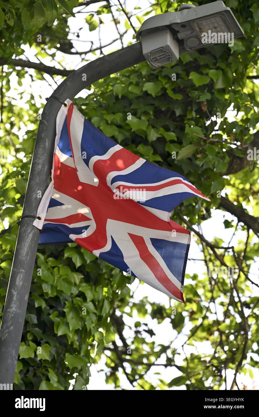 Bandiera britannica legata e sventolata su lampione stradale, Bedminster, Bristol, Regno Unito Foto Stock