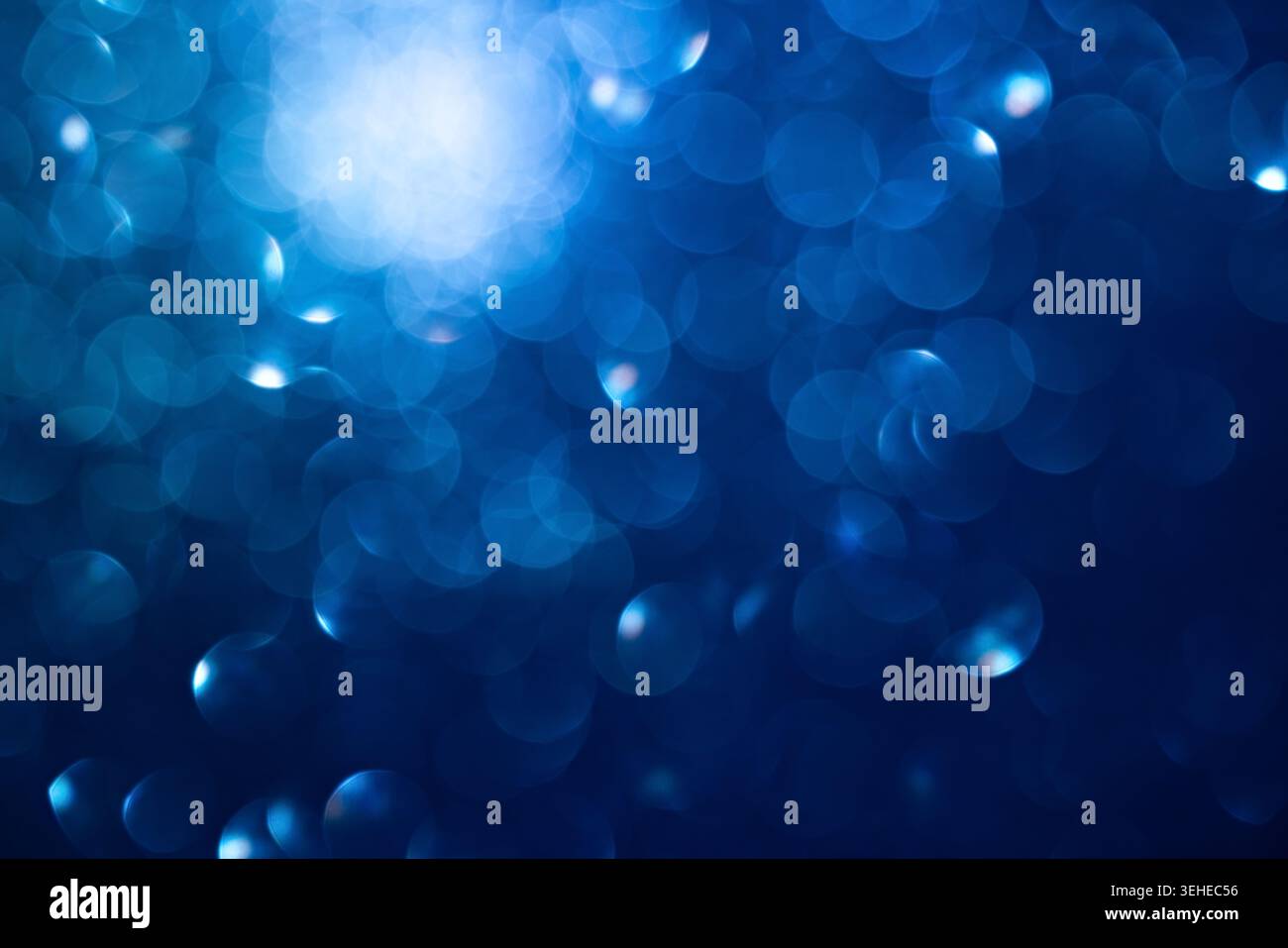 Sfondo bokeh blu astratto con luci soffuse e cerchi scintillanti Foto Stock