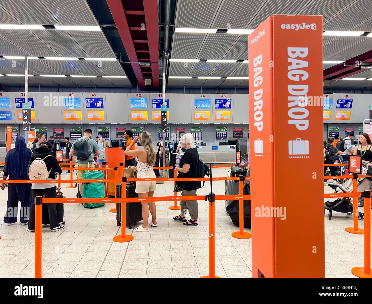 I clienti easyJet fanno la fila al Bad Drop per lasciare i loro bagagli all'aeroporto di Luton London nel Regno Unito Foto Stock