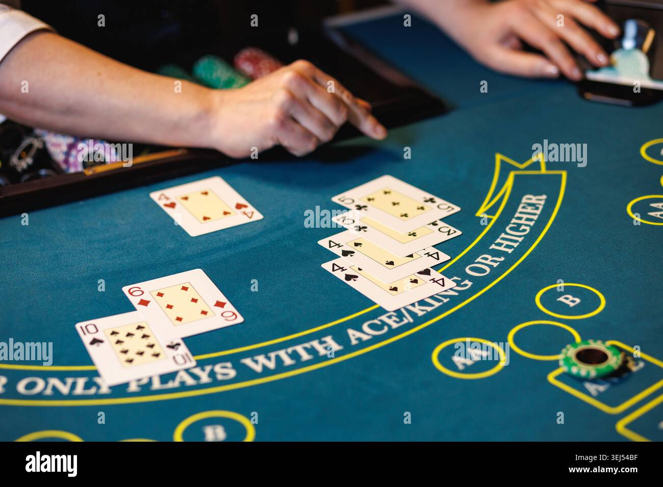 Casino Poker Table con carte da gioco e mani del dealer Foto Stock