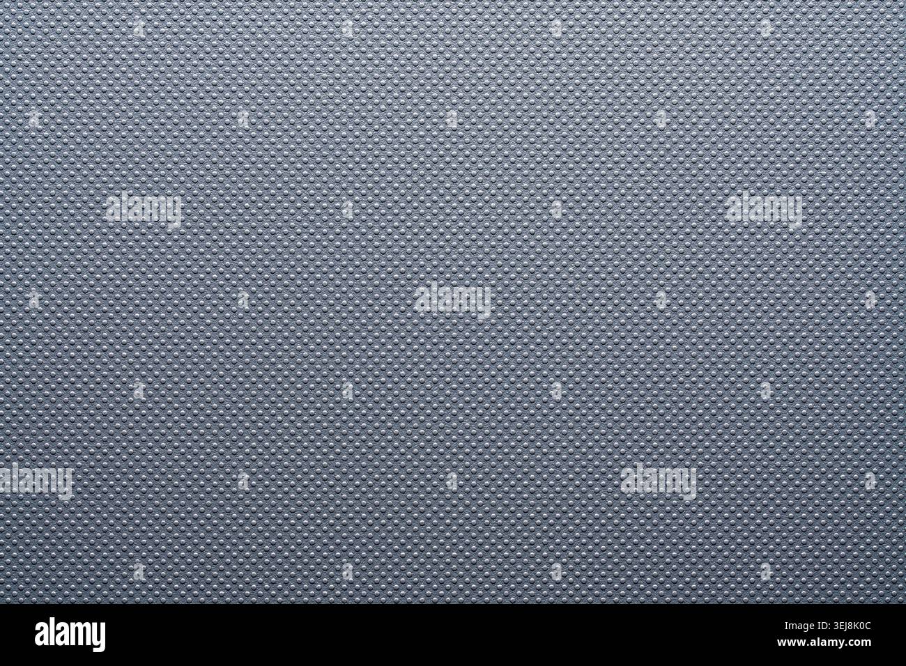 Primo piano di materiale sintetico grigio scuro con una piccola texture tratteggiata in rilievo. Sfondo astratto pulito per il settore automobilistico industriale e il prodotto tecnologico de Foto Stock