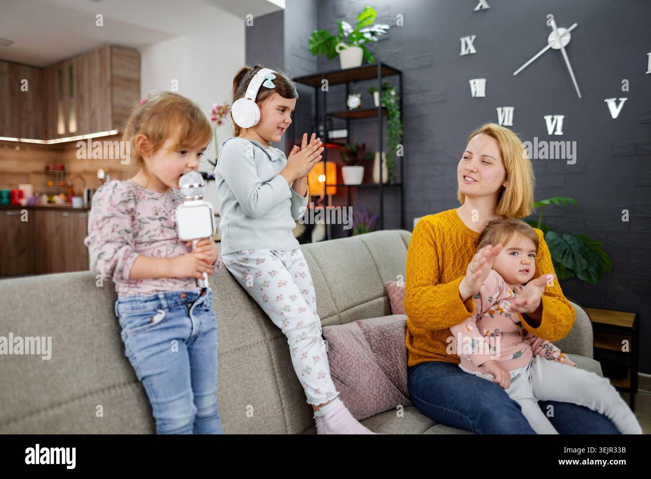 La madre e le sue tre figlie hanno una festa karaoke Foto Stock