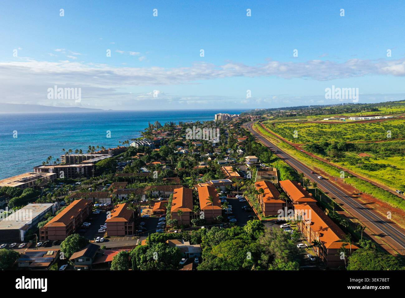 Una vista aerea della città di Lahaina sull'isola di Maui, Hawaii, caratterizzata da una vegetazione lussureggiante, una vibrante strada costiera e acque turchesi del Pacific Oce Foto Stock