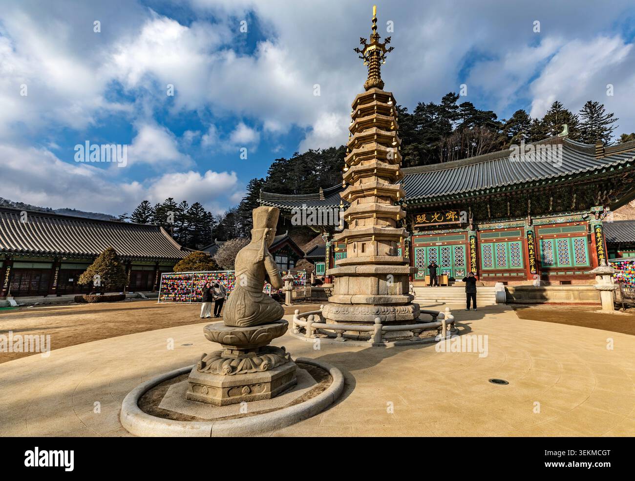 Le persone visitano la pagoda ottagonale in pietra a nove piani e la statua di Bodhisattva inginocchiata nel cortile del tempio di Woljeongsa, Pyeongchang, Corea del Sud Foto Stock