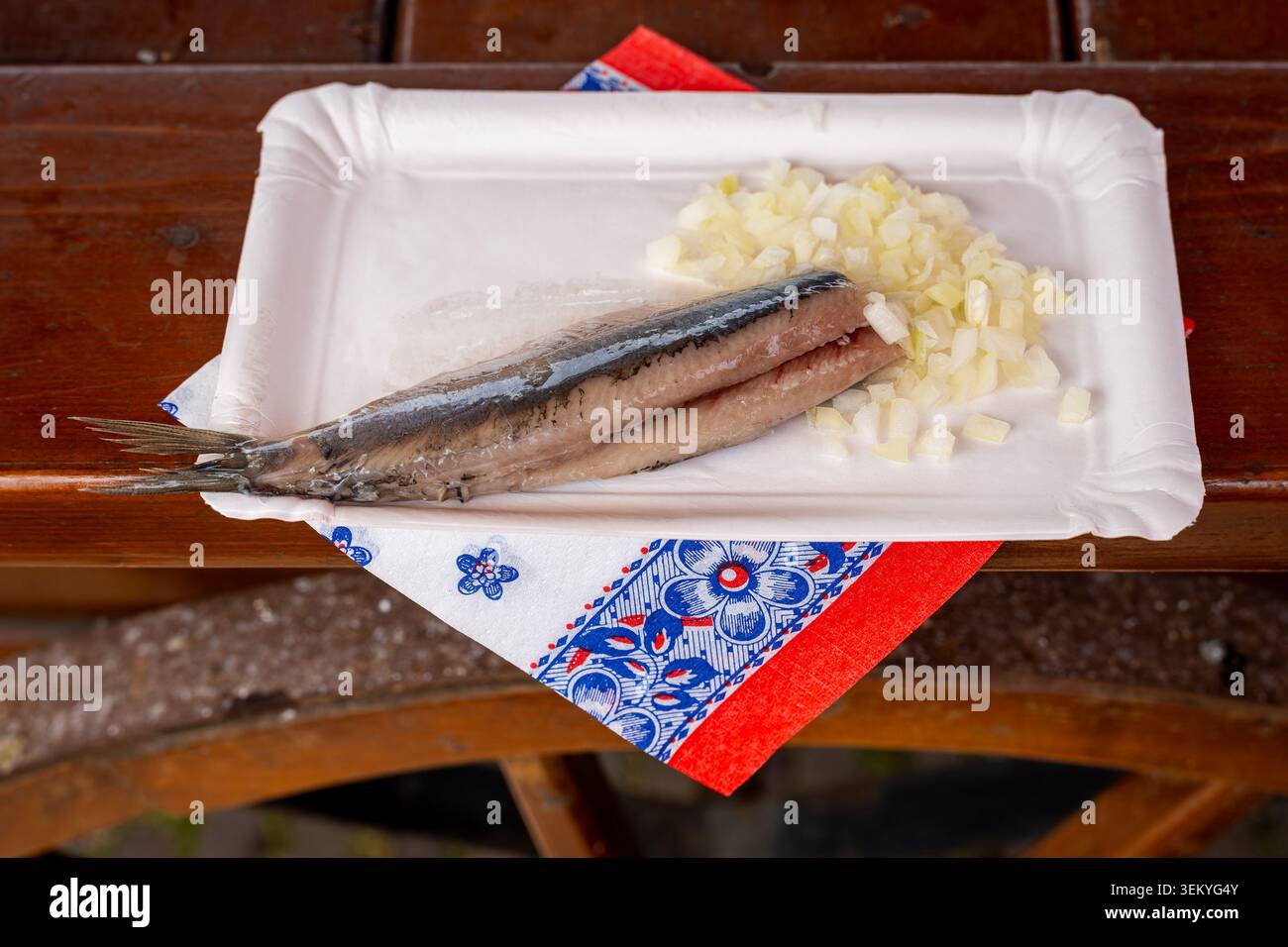 Aringhe tradizionali olandesi in zuppa con cipolle tritate servite al mercato del pesce all'aperto Foto Stock