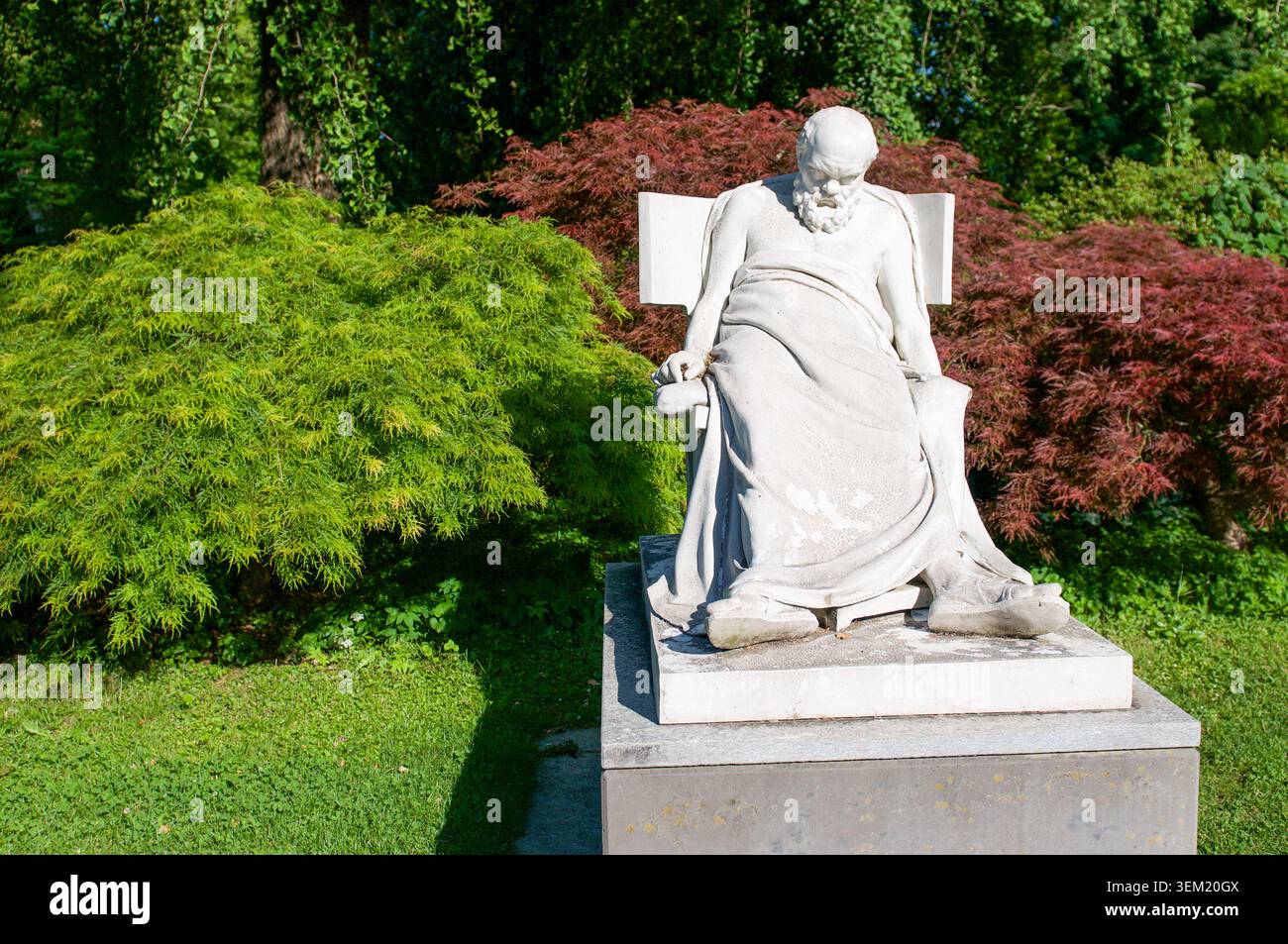 Vista ad alto angolo della storica scultura in marmo bianco Socrate Mourant circondata da alberi d'acero giapponesi rossi e verdi. Patrimonio culturale, belle arti Foto Stock