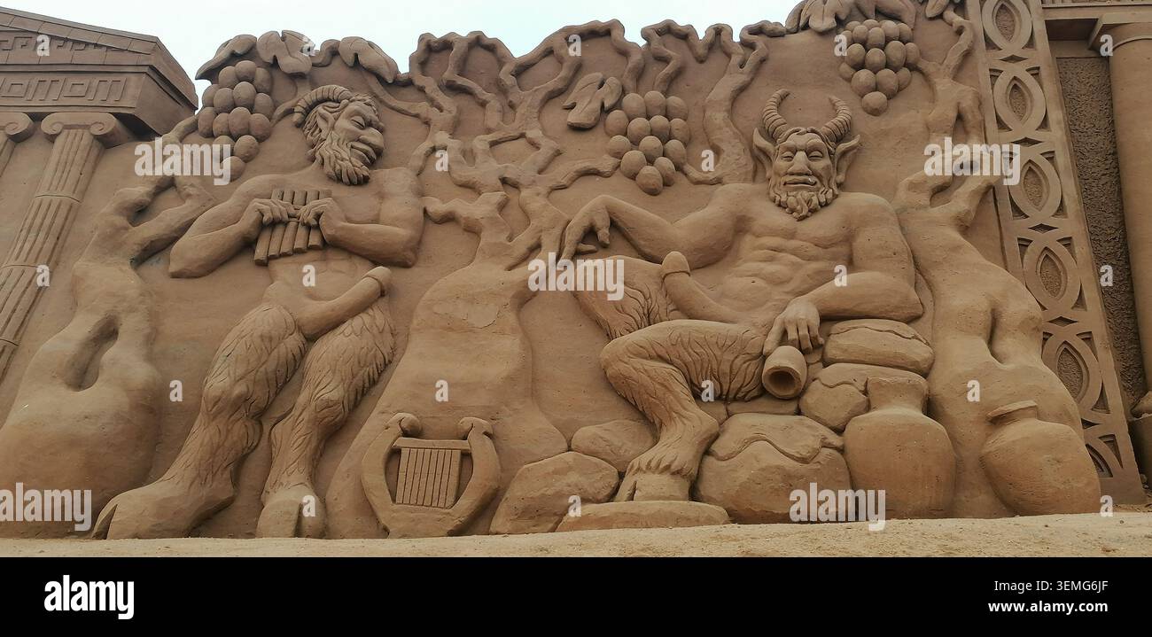 Intricate sculture di sabbia raffiguranti la mitologia greca, Petra e figure leggendarie durante un festival internazionale di arte della sabbia - Immagine stock catturata con smartphone
