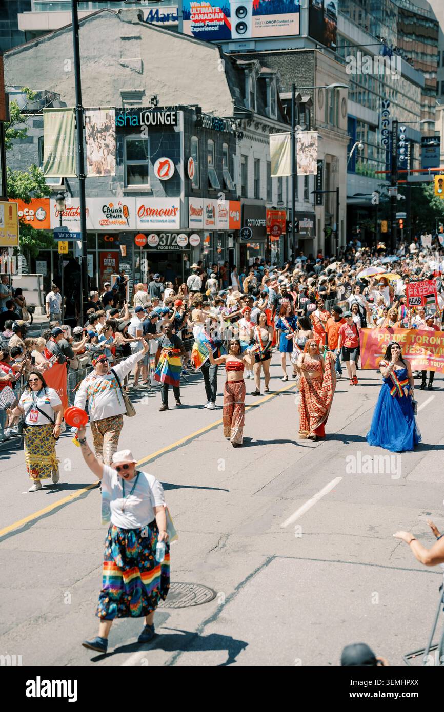 Toronto, Canada - 29 giugno 2025: La processione festiva degli artisti culturali anziani si sposta lungo la vivace città Foto Stock