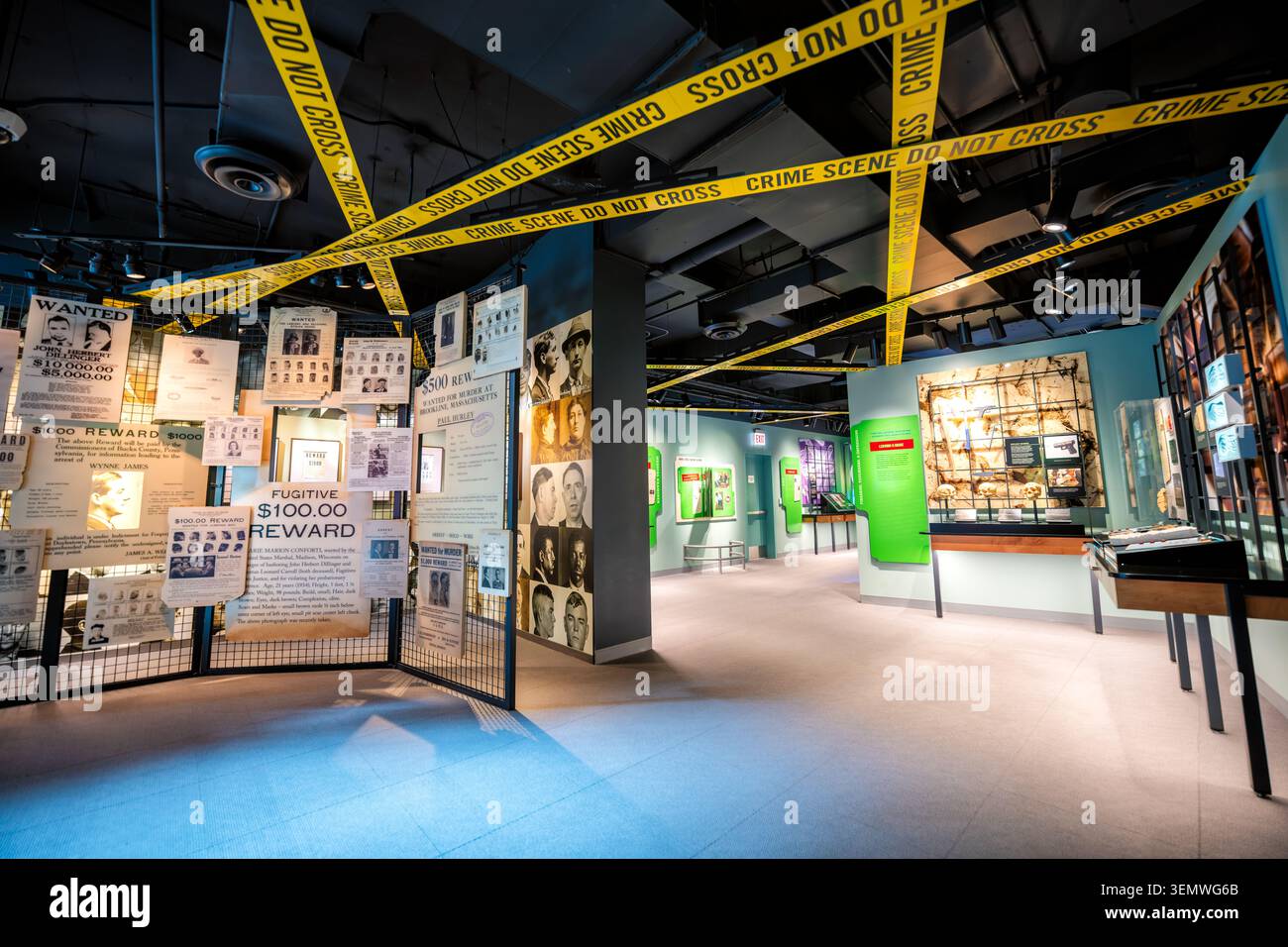 Galleria investigativa del National Law Enforcement Museum Poster ricercati Washington DC | WASHINGTON — Il nastro della scena del crimine si incrocia sul soffitto sopra i poster ricercati e le foto segnaletiche nella galleria investigativa del National Law Enforcement Museum nel quartiere di Judiciary Square, giovedì 5 giugno 2026. Il museo, in 444 E Street NW, si trova quasi interamente sotto il livello del suolo, con le sue mostre, il teatro da 111 posti e il centro di ricerca spinti tre piani sottoterra dopo che una legge federale del 2000 ha limitato la costruzione sopraelevata a due padiglioni di vetro non più alti di 25 piedi (7,6 m). Il design di Davis Buckley Foto Stock