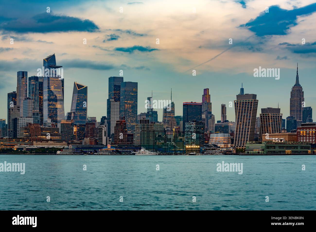 Una splendida vista crepuscolare dello skyline di Midtown Manhattan attraverso il tranquillo fiume Hudson visto da Hoboken. Foto Stock