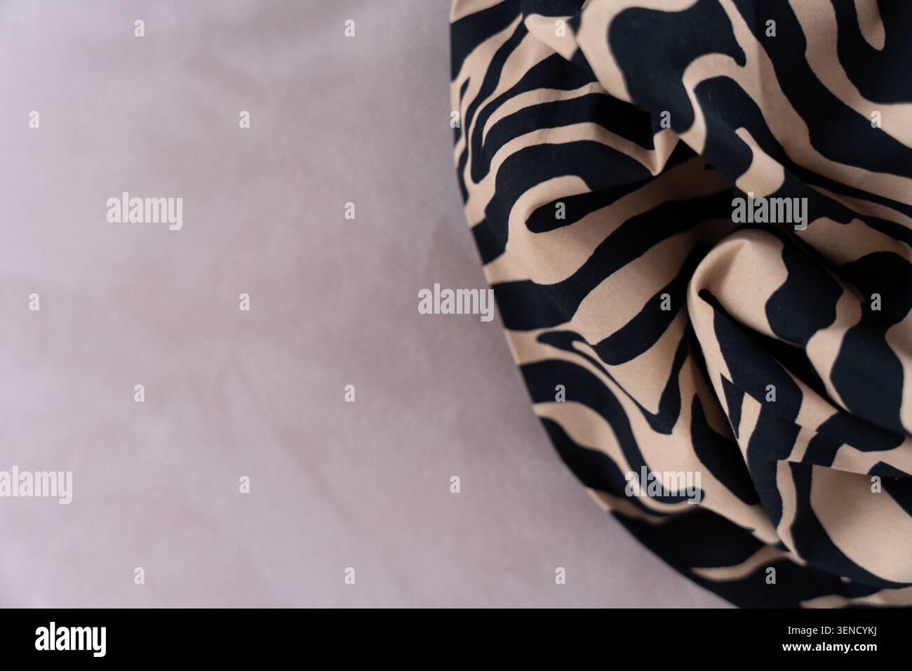 Tessuto con stampa zebra con motivo beige e nero su sfondo morbido, primo piano con spazio per le copie Foto Stock