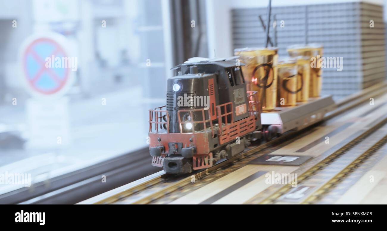 Treno in miniatura sui binari che trasporta bevande in un bar o ristorante Foto Stock