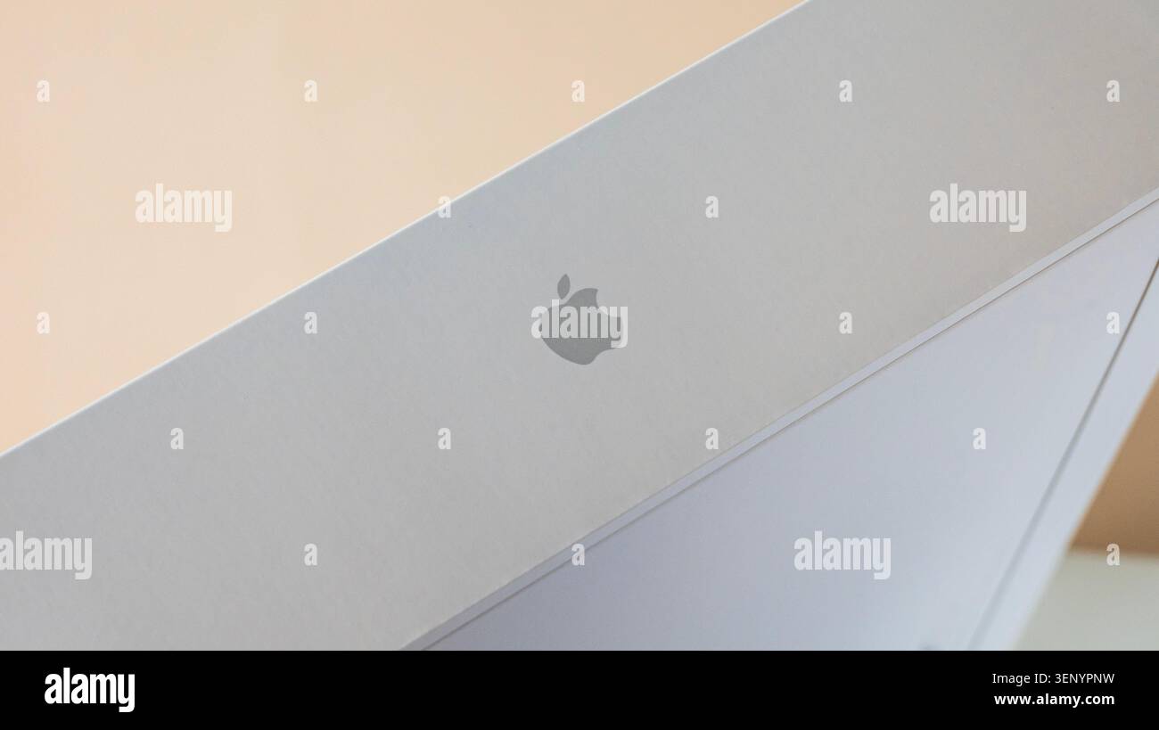 Neuss, Germania, 10.06.2026 - primo piano del logo Apple stampato su una confezione di prodotti bianca minimalista su un morbido sfondo beige, tecnologia pulita ae Foto Stock