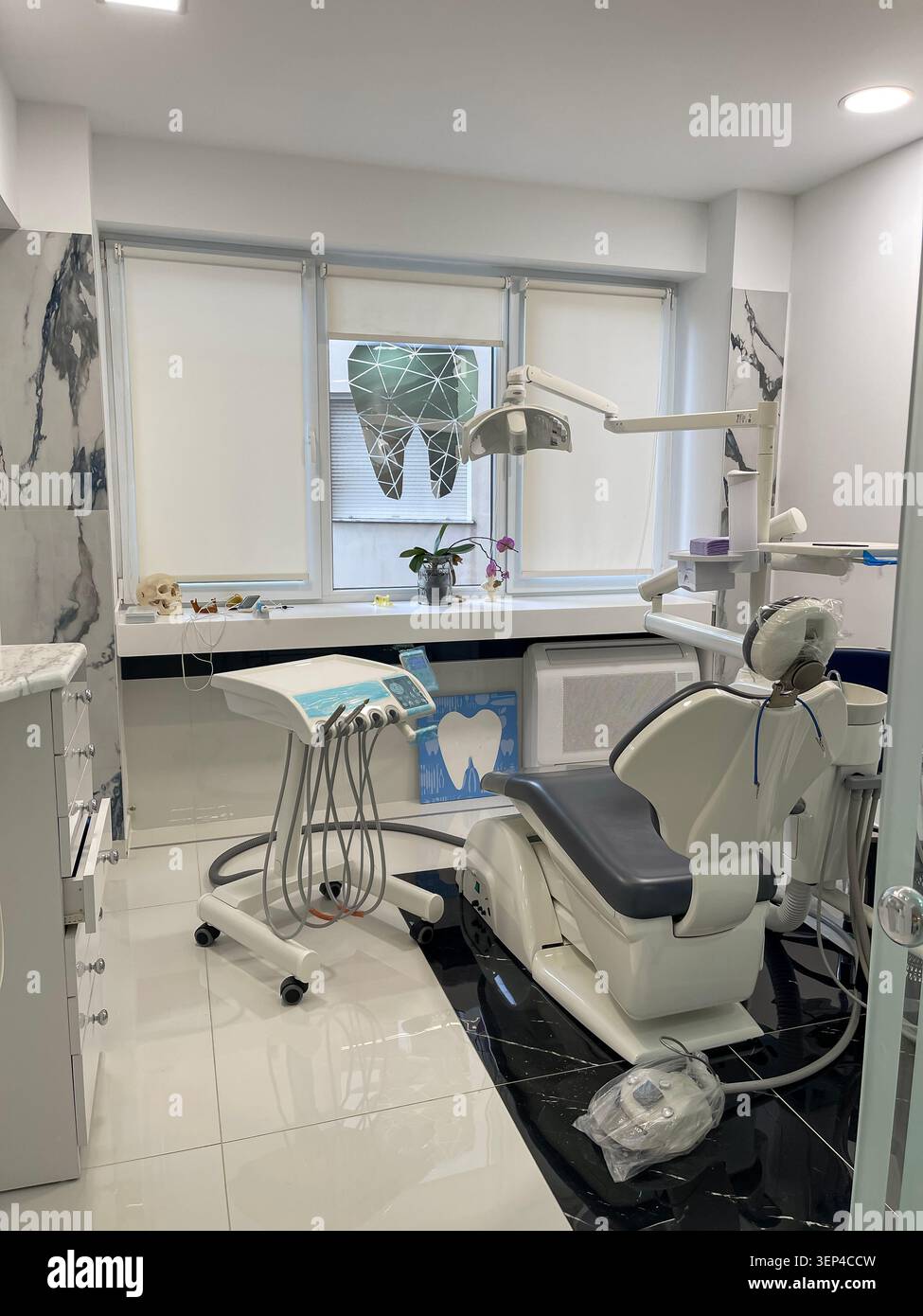 Interno moderno di una clinica dentale con sedia per trattamenti e attrezzature mediche professionali. - Immagine stock catturata con smartphone