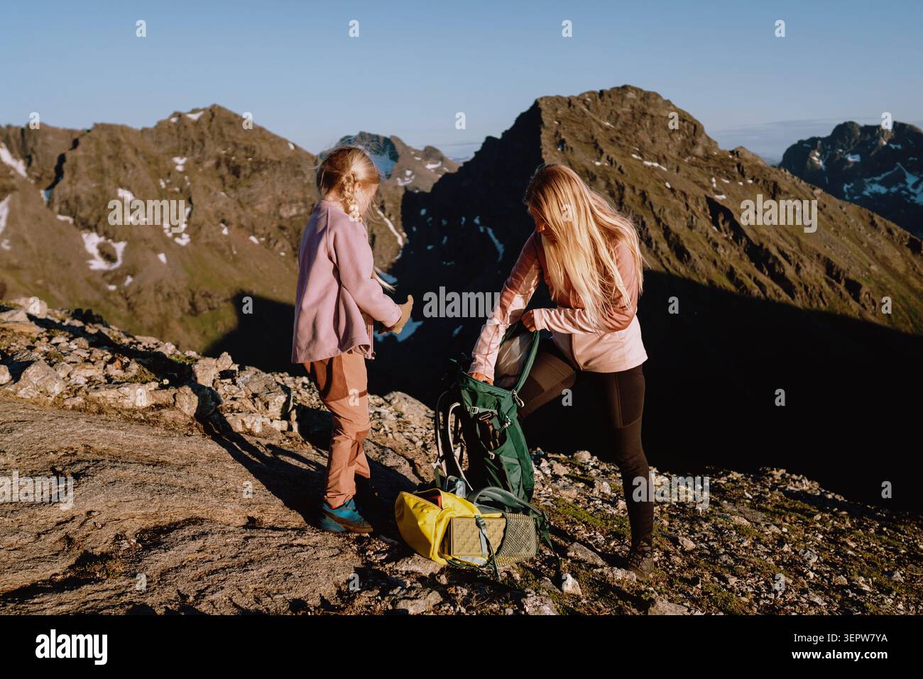 Famiglia madre e bambino escursioni in montagna zaini in valigia, vacanze estive in Norvegia persone genitori e figlia in un viaggio in campeggio attivo insieme e pubblicità Foto Stock