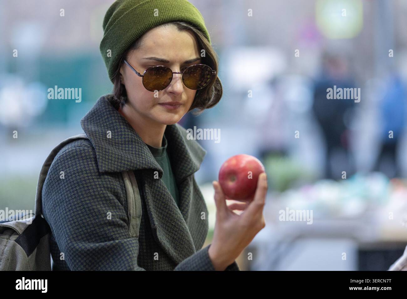 Ritratto di donna con mela rossa al mercato di strada Foto Stock