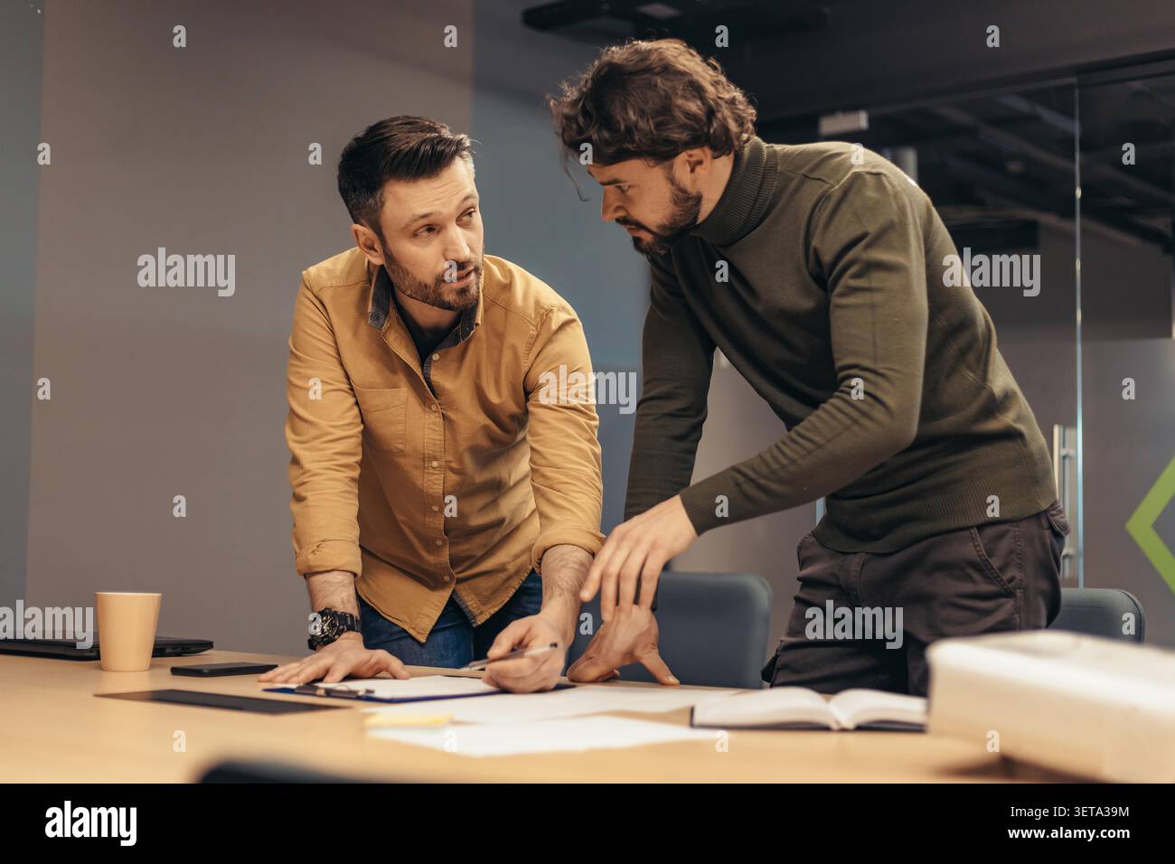 Due giovani che collaborano e discutono idee in Modern Office, Business Concept Foto Stock