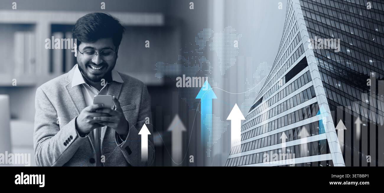 Imprenditore CEO indiano che naviga sul suo smartphone in un ufficio moderno Foto Stock