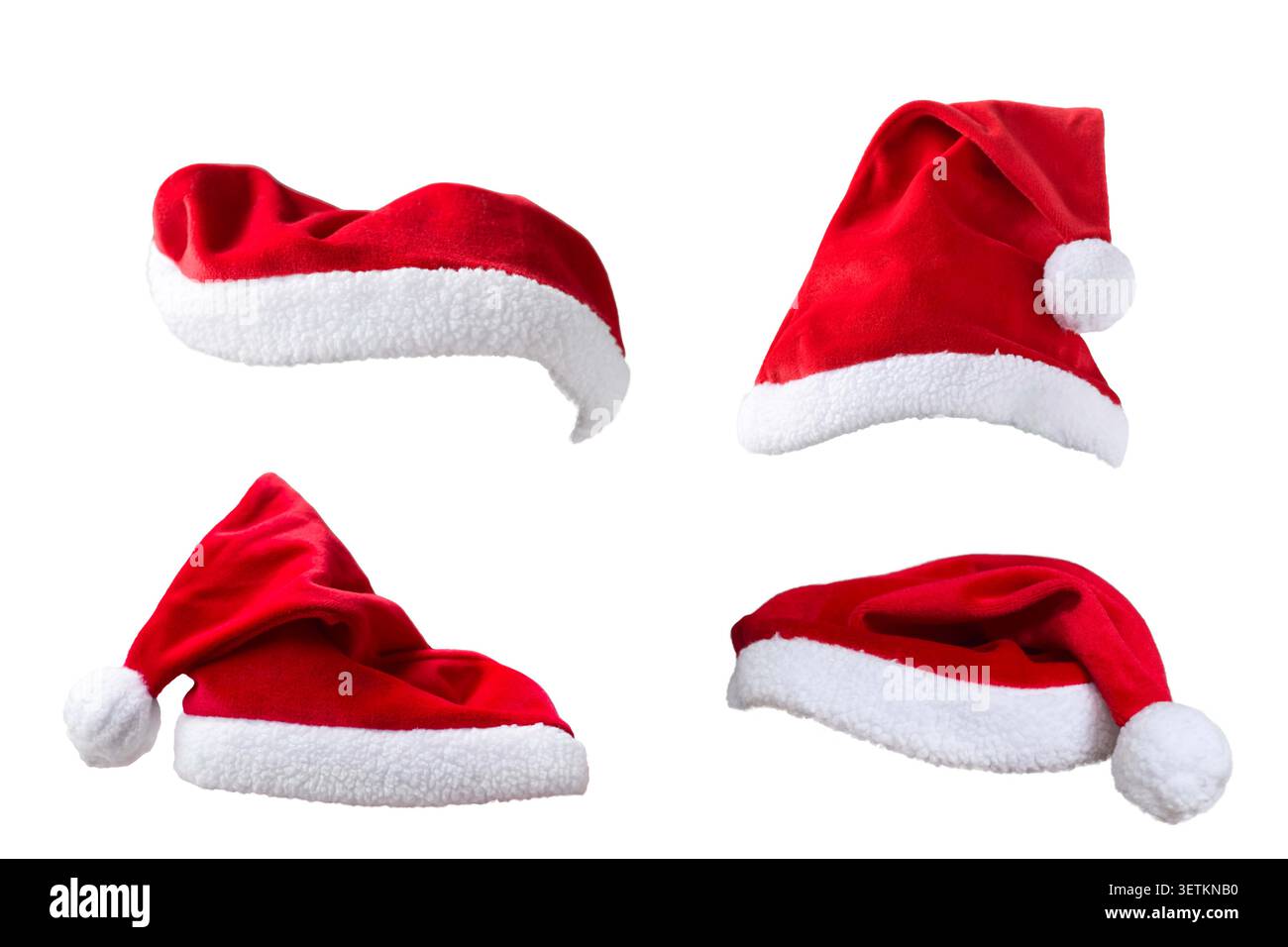 Gruppo di quattro cappelli di Babbo Natale rossi isolati su bianco Foto Stock