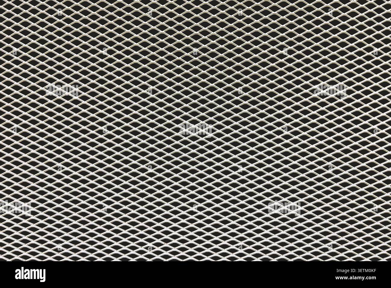 Primo piano della trama di mesh metallica espansa con motivo geometrico. Sfondo a griglia industriale in acciaio per concetti di progettazione, costruzione e tecnologia. Foto Stock