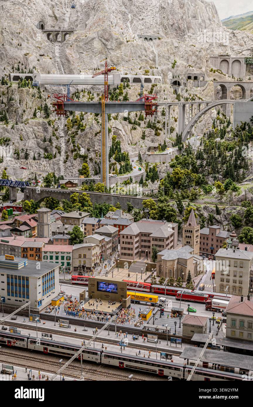 Diorama in miniatura dettagliato di una città alpina svizzera con una stazione ferroviaria, un concerto all'aperto e un grande ponte in cemento in costruzione Foto Stock