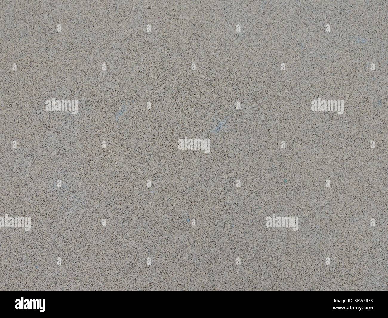 Una texture opaca a grana fine in un colore grigio-beige. La superficie uniforme e ruvida assomiglia a calcestruzzo lucidato, trucioli di granito o intonaco Foto Stock
