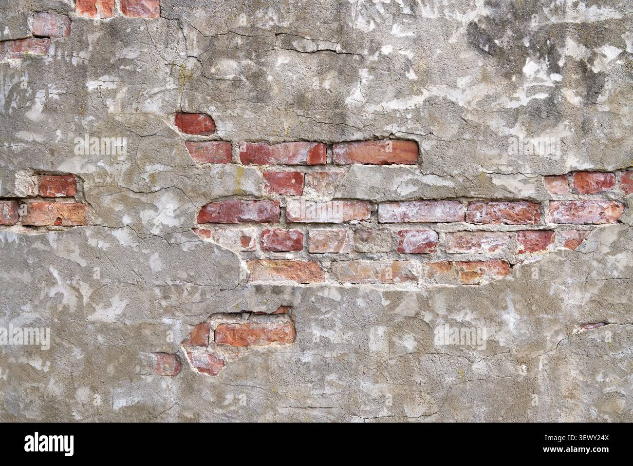 Dettaglio di una vecchia parete industriale - mattoni con intonaco grigio Foto Stock