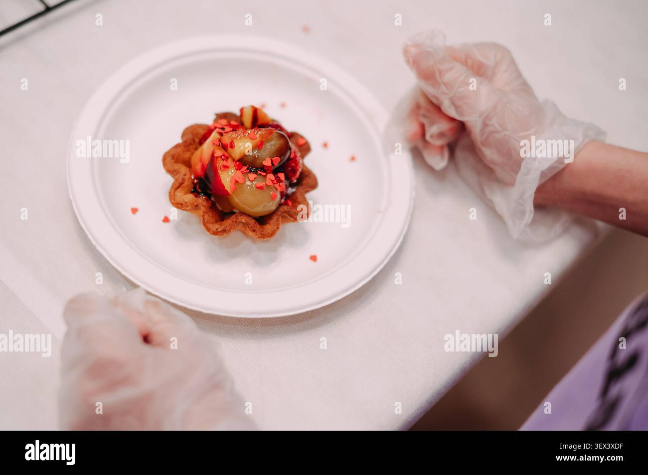 Crostata di frutta fresca con pesche e frutti di bosco su piatto bianco preparato dallo chef Foto Stock