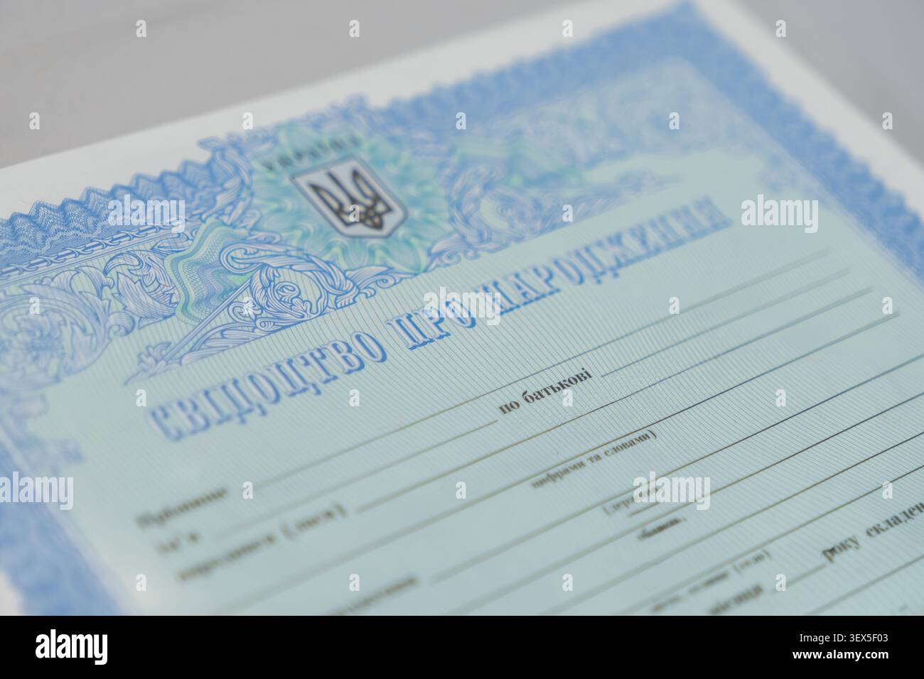 Kiev, Ucraina - 21 marzo 2026: Primo piano di un autentico certificato di nascita con motivi blu ornati e il sigillo nazionale utilizzato per gli offici Foto Stock