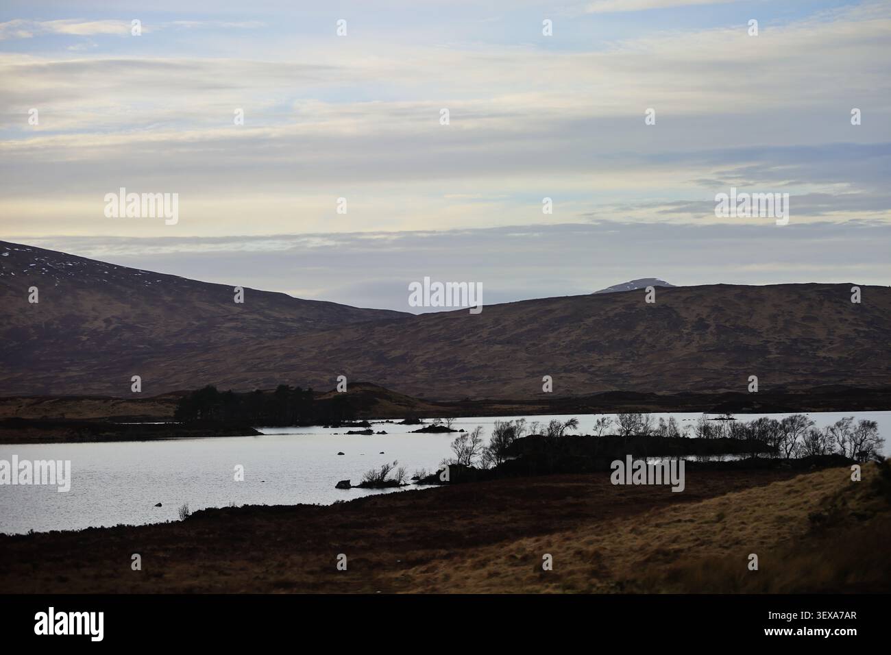 Il punto panoramico di Loch Ba nelle Highlands scozzesi, in Scozia, presenta l'acqua di loch, colline scure e strati di nuvole, mentre il basso litorale ne forma la composizione. Foto Stock