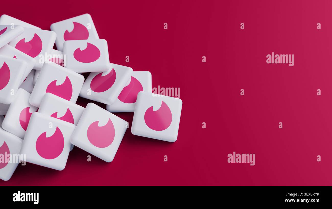 Logo della piattaforma di incontri online Tinder in una grande pila su sfondo rosso con spazio di copia come intestazione banner Web Foto Stock