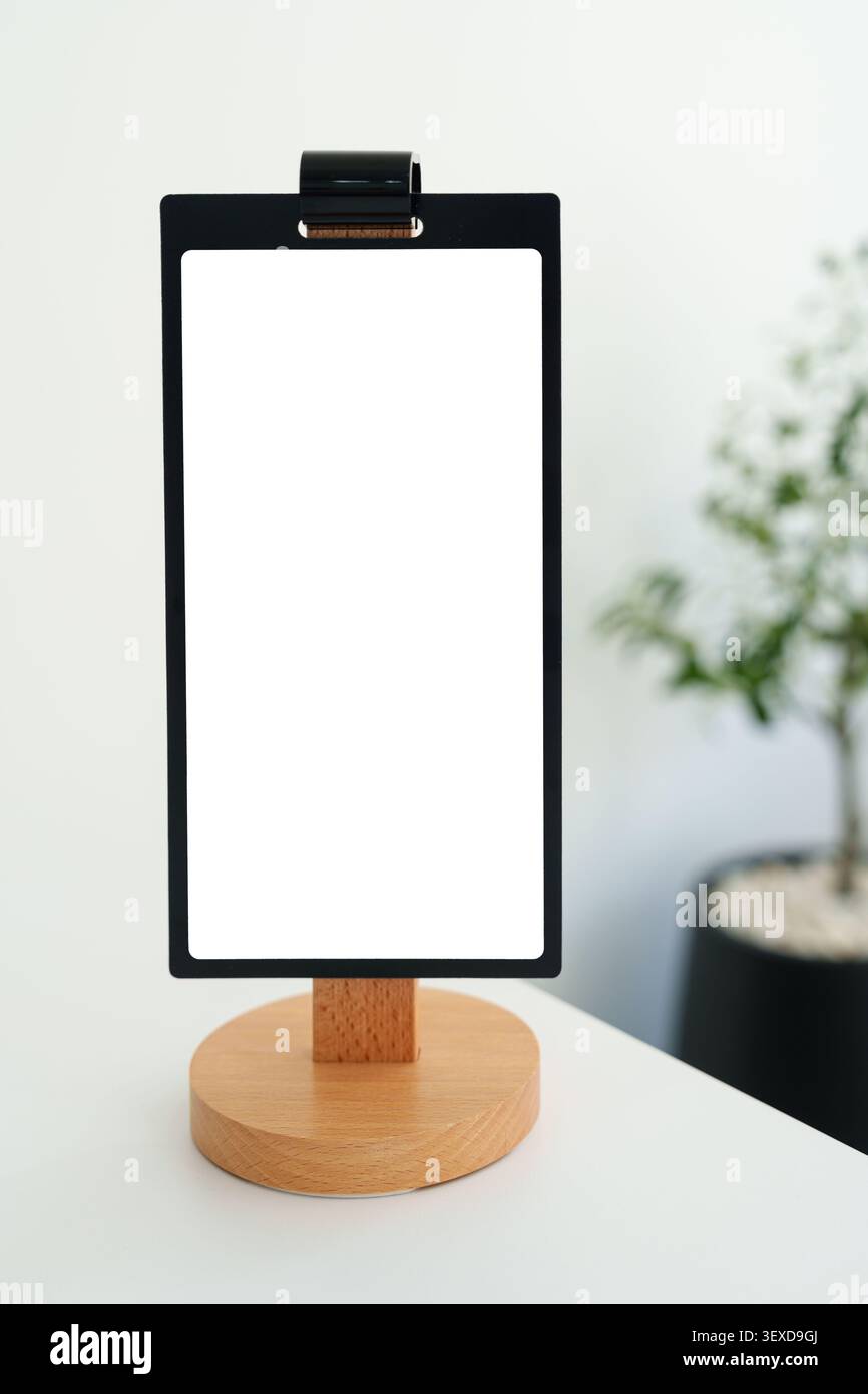 Moderno menu da tavolo vuoto con piedistallo in legno e struttura nera per la personalizzazione presso il caffè bianco interno Foto Stock