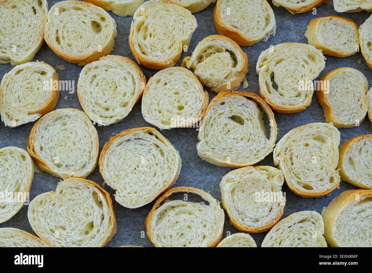 Fette di pane su una teglia, primo piano, vista dall'alto. Pane fatto in casa Foto Stock