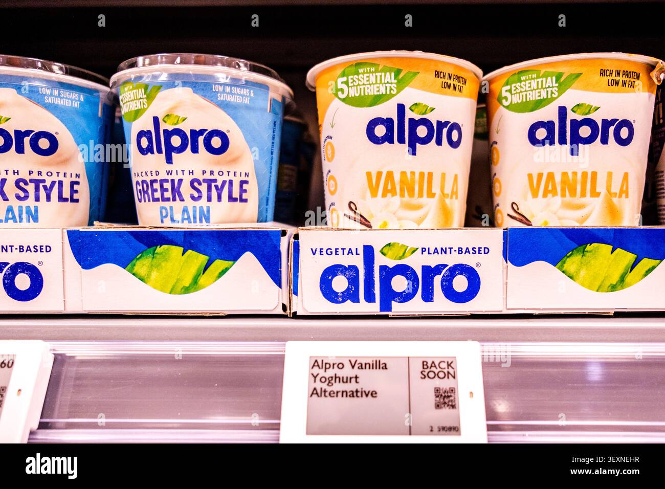 Londra Regno Unito, 1 luglio 2026, Supermarket display of Alpro Greek Style Plant Based Plain and Vanilla yogurt pot with No People Foto Stock