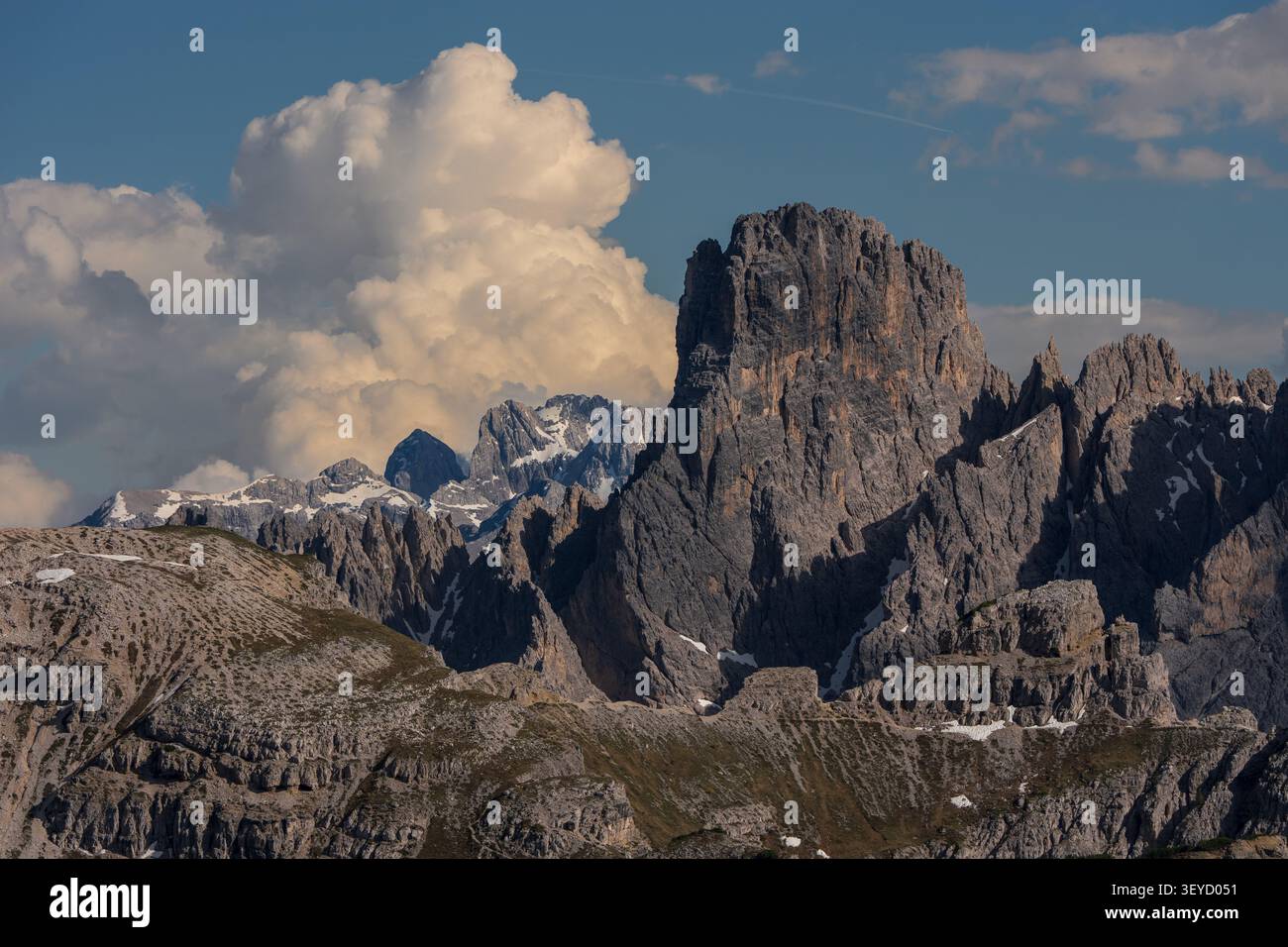 Picchi frastagliati di dolomia che si innalzano sotto nuvole drammatiche, concetto di paesaggio di formazione rocciosa alpina scenografica. Foto Stock