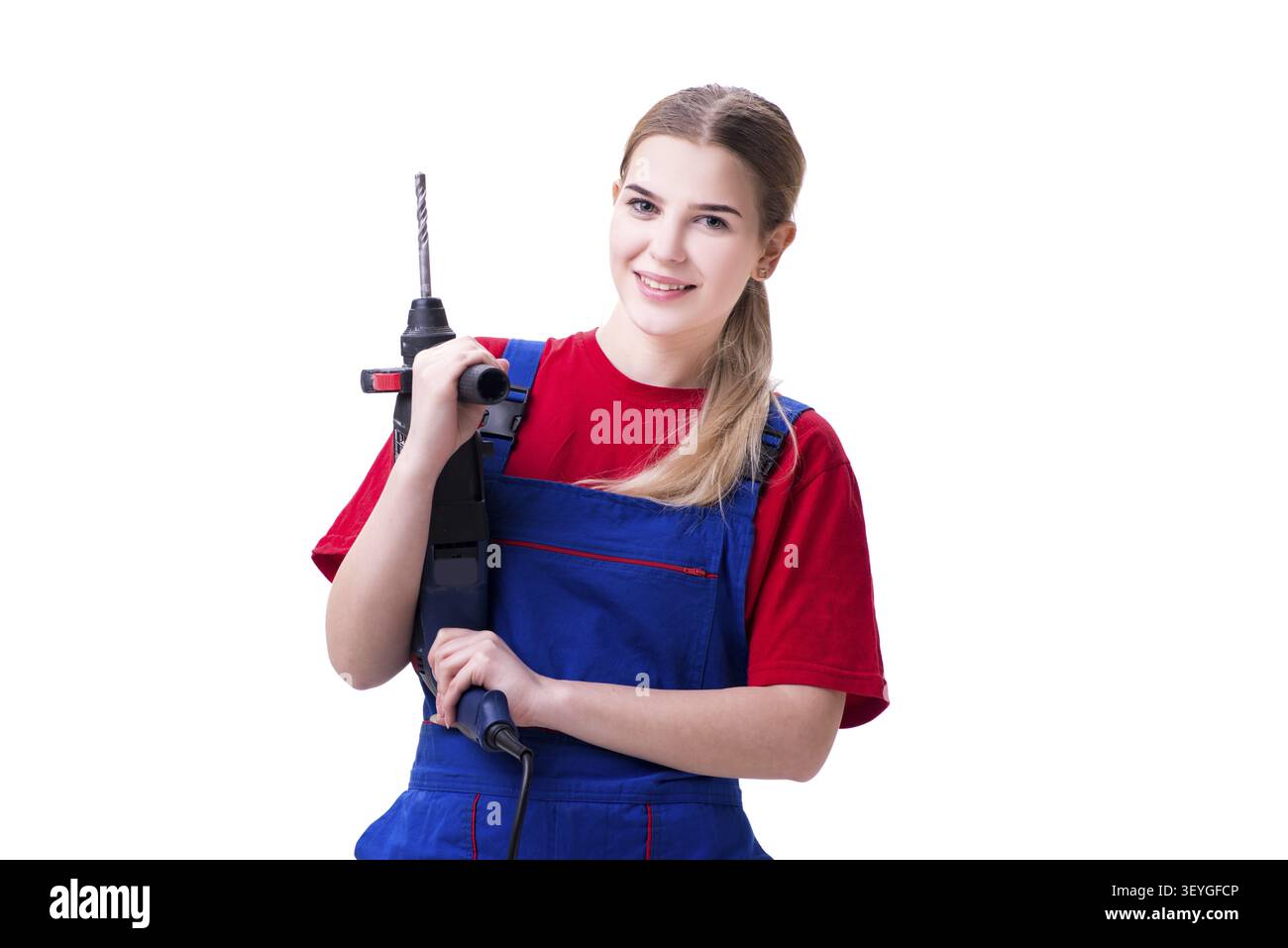 Giovane donna con il trapano elettrico isolato su bianco Foto Stock