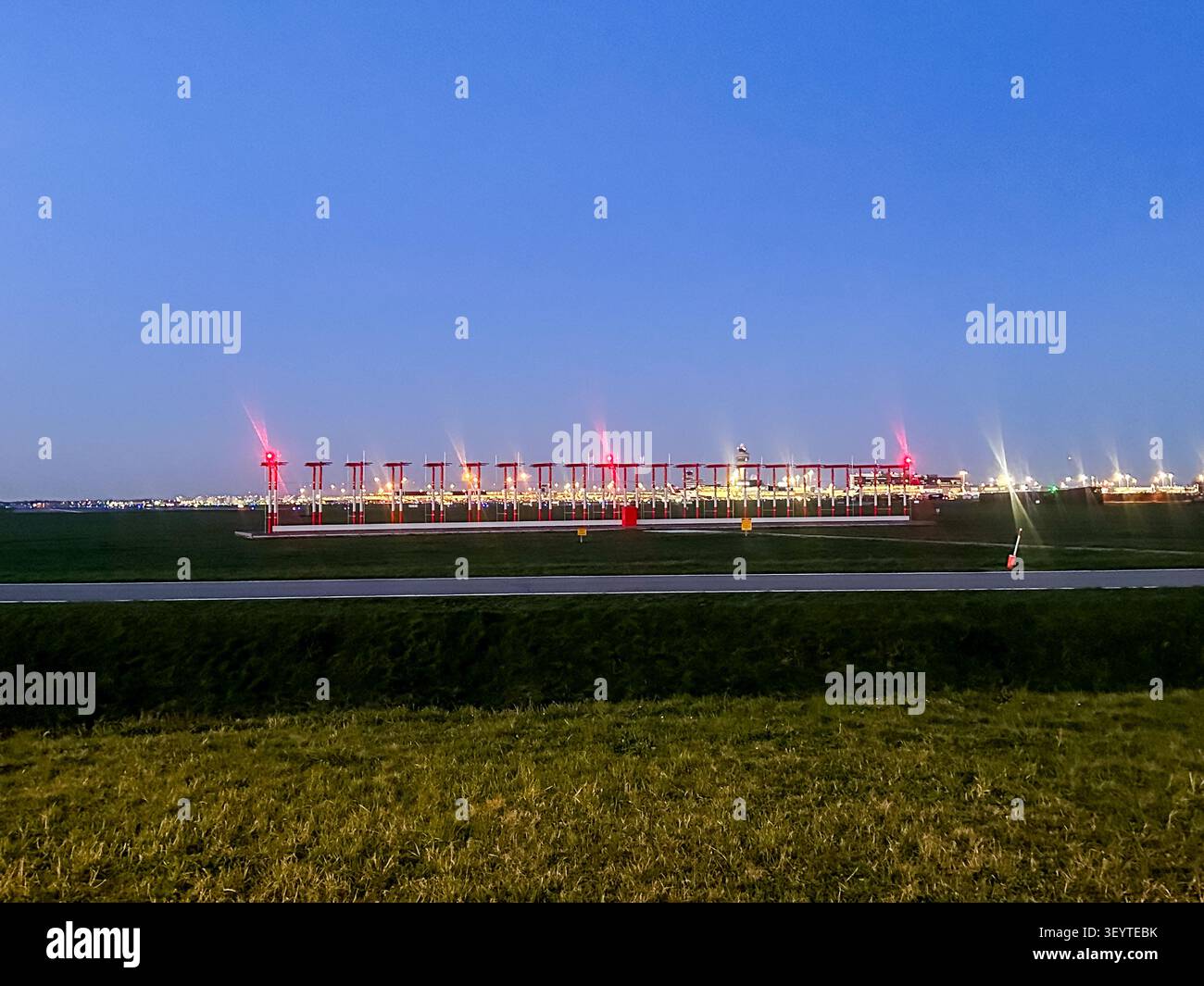 Sistema di illuminazione per l’avvicinamento alla pista dell’aeroporto di Schiphol al crepuscolo vicino all’Aeroporto di Amsterdam Schiphol, Paesi Bassi. Foto Stock
