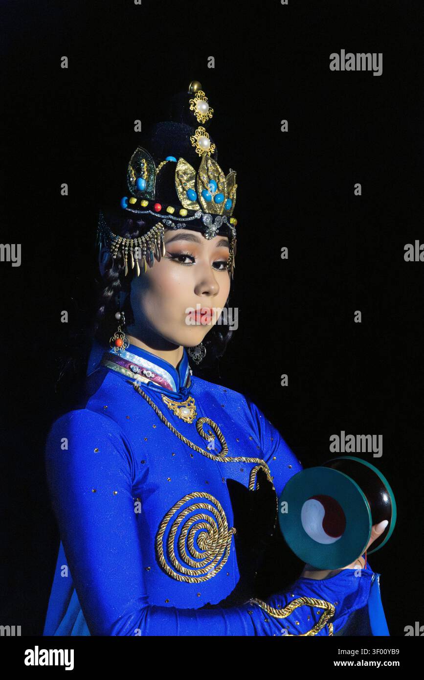 Interprete in costume tradizionale con piatti al Tumen Ekh Ensemble di Ulan Bator, Mongolia. Foto Stock